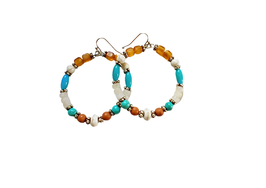 Multi-Color Hoop Earrings featuring vibrant handmade beads arranged in a boho style design, perfect for women who love colorful, trendy jewelry. These lightweight earrings are ideal for festivals, casual outings, or adding a playful touch to any outfit. Crafted with care, they offer comfortable wear and eye-catching appeal, making them a thoughtful gift for her. The bold mix of colors and intricate beadwork create a fun, artistic accessory that celebrates free-spirited, bohemian fashion.