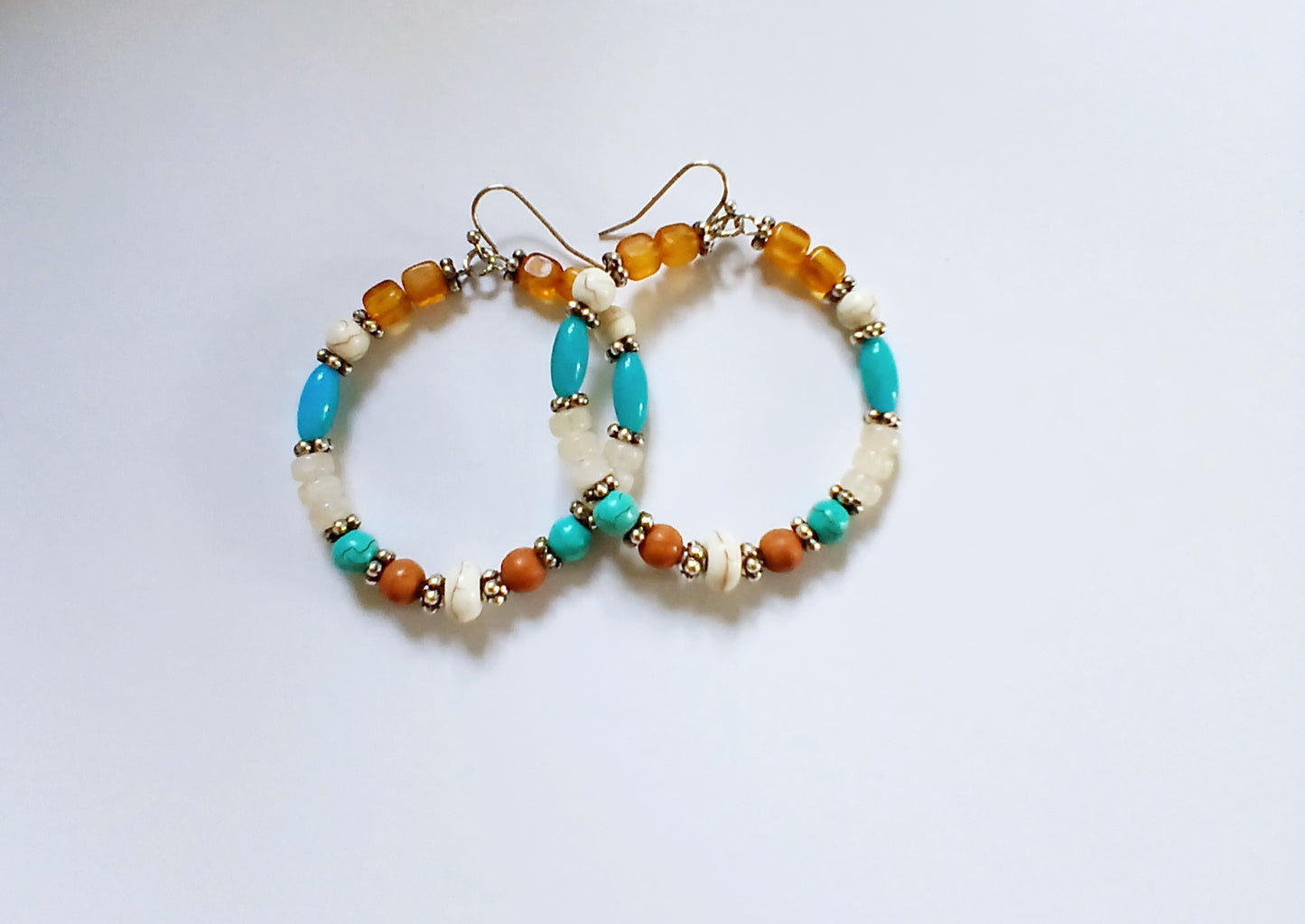 Multi-Color Hoop Earrings featuring vibrant handmade beads arranged in a boho style design, perfect for women who love colorful, trendy jewelry. These lightweight earrings are ideal for festivals, casual outings, or adding a playful touch to any outfit. Crafted with care, they offer comfortable wear and eye-catching appeal, making them a thoughtful gift for her. The bold mix of colors and intricate beadwork create a fun, artistic accessory that celebrates free-spirited, bohemian fashion.