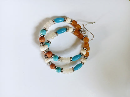 Multi-Color Hoop Earrings featuring vibrant handmade beads arranged in a boho style design, perfect for women who love colorful, trendy jewelry. These lightweight earrings are ideal for festivals, casual outings, or adding a playful touch to any outfit. Crafted with care, they offer comfortable wear and eye-catching appeal, making them a thoughtful gift for her. The bold mix of colors and intricate beadwork create a fun, artistic accessory that celebrates free-spirited, bohemian fashion.