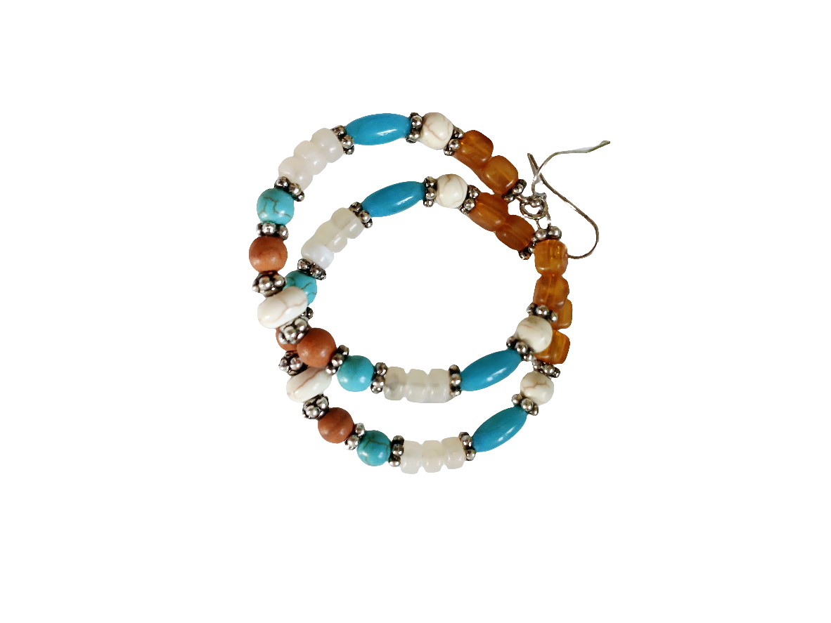 Multi-Color Hoop Earrings featuring vibrant handmade beads arranged in a boho style design, perfect for women who love colorful, trendy jewelry. These lightweight earrings are ideal for festivals, casual outings, or adding a playful touch to any outfit. Crafted with care, they offer comfortable wear and eye-catching appeal, making them a thoughtful gift for her. The bold mix of colors and intricate beadwork create a fun, artistic accessory that celebrates free-spirited, bohemian fashion.