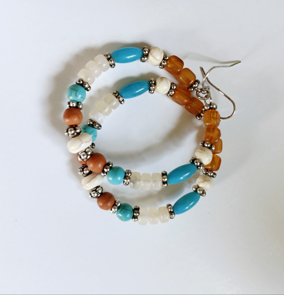 Multi-Color Hoop Earrings featuring vibrant handmade beads arranged in a boho style design, perfect for women who love colorful, trendy jewelry. These lightweight earrings are ideal for festivals, casual outings, or adding a playful touch to any outfit. Crafted with care, they offer comfortable wear and eye-catching appeal, making them a thoughtful gift for her. The bold mix of colors and intricate beadwork create a fun, artistic accessory that celebrates free-spirited, bohemian fashion.