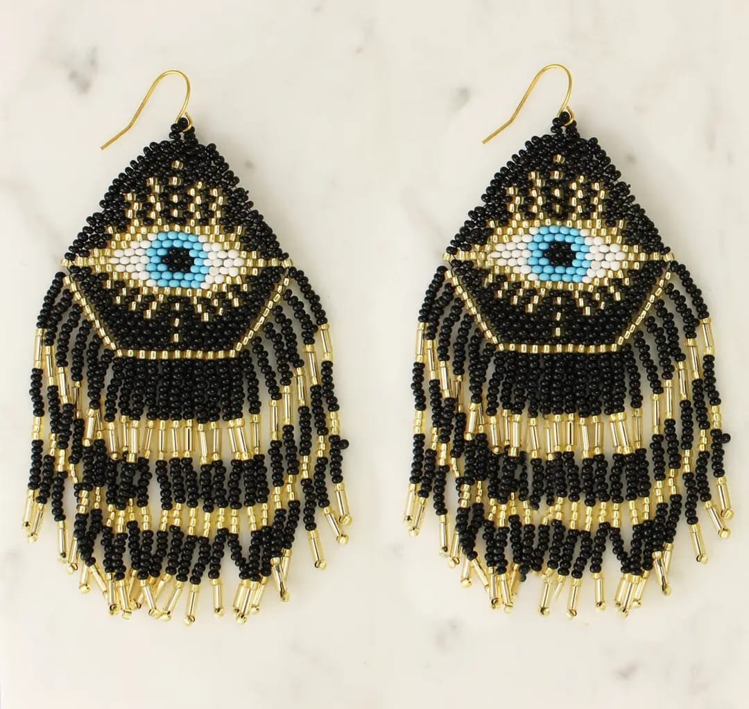 Mystical Eye Seed Bead Fringe Earrings featuring intricate handmade tribal designs with colorful seed bead fringes. These unique boho statement earrings offer bold dangles that capture attention with their vibrant colors and artistic craftsmanship. Perfect for women who love expressive, culturally inspired jewelry, they make an ideal gift for festivals, special occasions, or everyday wear. Lightweight and eye-catching, these earrings add a free-spirited, mystical touch to any outfit.