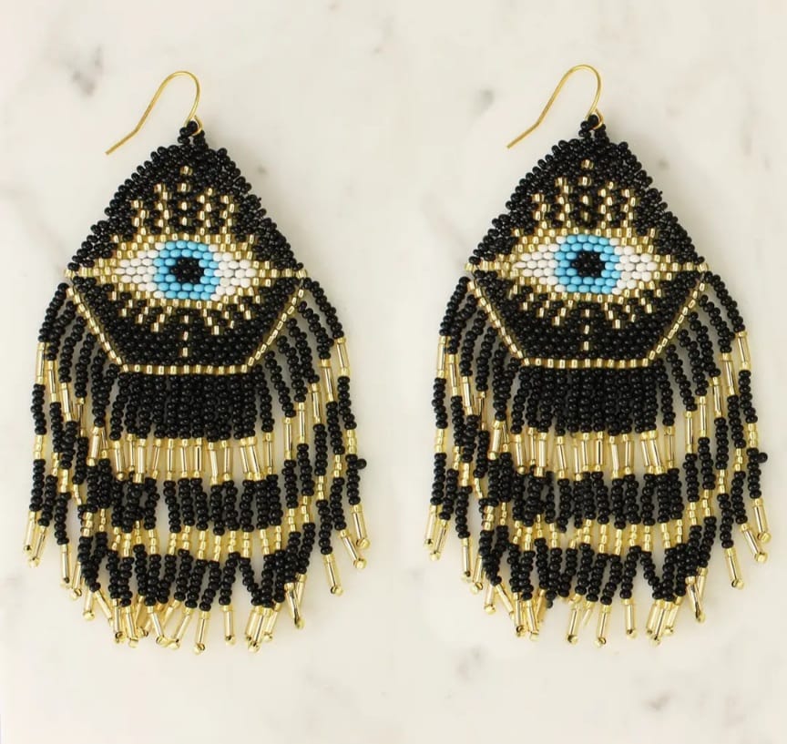 Mystical Eye Seed Bead Fringe Earrings featuring intricate handmade tribal designs with colorful seed bead fringes. These unique boho statement earrings offer bold dangles that capture attention with their vibrant colors and artistic craftsmanship. Perfect for women who love expressive, culturally inspired jewelry, they make an ideal gift for festivals, special occasions, or everyday wear. Lightweight and eye-catching, these earrings add a free-spirited, mystical touch to any outfit.