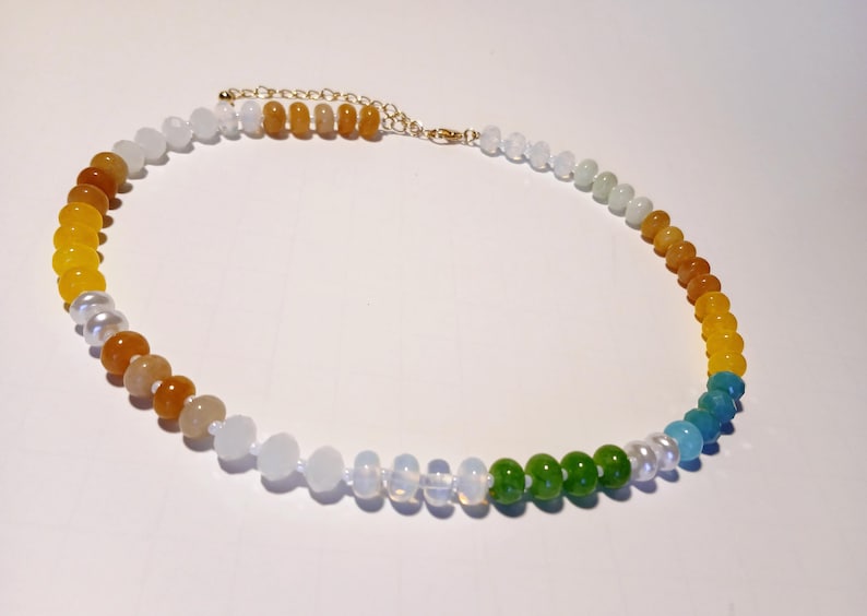 Natural Agate and Glass Beaded Necklace featuring a vibrant multicolor design, handcrafted for women who love bold and unique statement jewelry. This one-of-a-kind crystal necklace blends natural agate stones with colorful glass beads, offering artistic flair and healing energy. Lightweight and eye-catching, it makes a perfect gift for her, ideal for special occasions or everyday wear. A stunning example of handmade craftsmanship and boho-chic crystal jewelry.