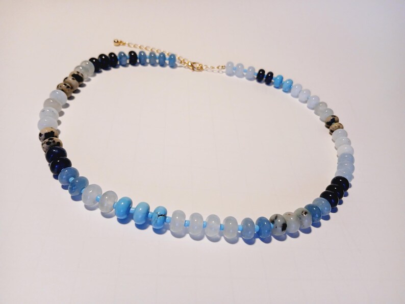 Natural Agate and Glass Beaded Necklace featuring a handcrafted design made with unique gemstone beads, perfect for women who love artistic and natural jewelry. This elegant agate necklace combines earthy tones and shimmering glass accents, creating a one-of-a-kind statement piece. Ideal as a thoughtful gift for her, it adds color and charm to any outfit. Lightweight and stylish, this handmade jewelry blends boho flair with the healing beauty of natural stones.
