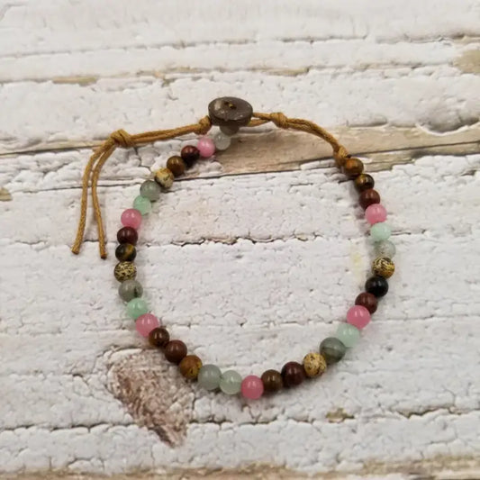 Natural stone and coconut shell beaded bracelet, handmade with eco-friendly materials, perfect for men and women who love earthy, boho style. This versatile bracelet features a unique blend of natural textures and colors, making it an ideal gift for her or him. Comfortable and durable, it adds a grounded, organic touch to any outfit. Perfect for casual wear, nature lovers, and those seeking sustainable, stylish jewelry with a meaningful vibe.