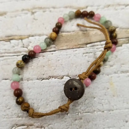 Natural stone and coconut shell beaded bracelet, handmade with eco-friendly materials, perfect for men and women who love earthy, boho style. This versatile bracelet features a unique blend of natural textures and colors, making it an ideal gift for her or him. Comfortable and durable, it adds a grounded, organic touch to any outfit. Perfect for casual wear, nature lovers, and those seeking sustainable, stylish jewelry with a meaningful vibe.