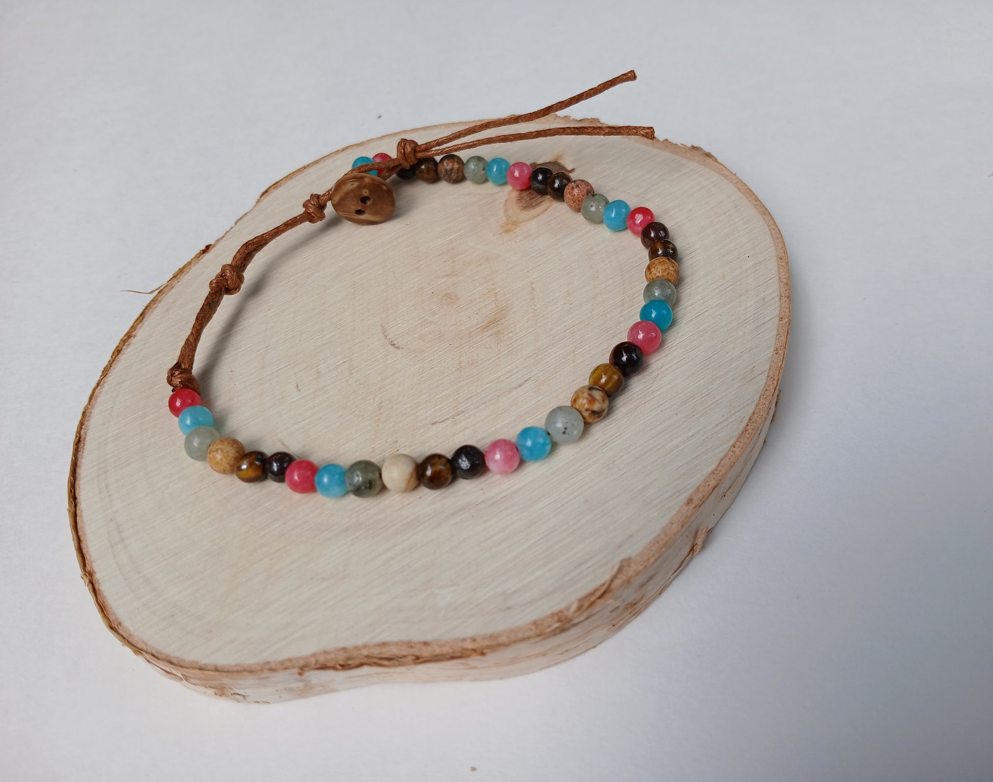 Natural stone and coconut shell beaded bracelet, handmade with eco-friendly materials, perfect for men and women who love earthy, boho style. This versatile bracelet features a unique blend of natural textures and colors, making it an ideal gift for her or him. Comfortable and durable, it adds a grounded, organic touch to any outfit. Perfect for casual wear, nature lovers, and those seeking sustainable, stylish jewelry with a meaningful vibe.