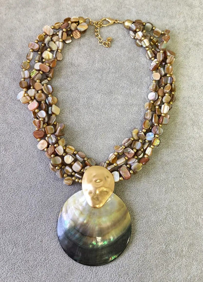 Neutral beige chip abalone pearl seashell pendant necklace featuring a handmade coastal boho design perfect for summer. This beach jewelry piece combines natural abalone chips, pearls, and seashell elements to evoke ocean-inspired elegance. Lightweight and versatile, it complements bohemian style with subtle earthy tones. An ideal gift for her, this necklace captures the serene beauty of the seaside and adds a chic touch to any outfit