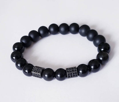 Black Obsidian Onyx Protection Bracelet handmade with natural crystal stones, including Hematite and Lava rock beads. This healing energy bracelet offers grounding and protective properties, perfect for men seeking balance, focus, and emotional strength. Ideal for yoga, meditation, or daily wear, the stylish charm design blends spiritual wellness with fashion. Unique crystal jewelry for men, handcrafted for holistic energy and intention.