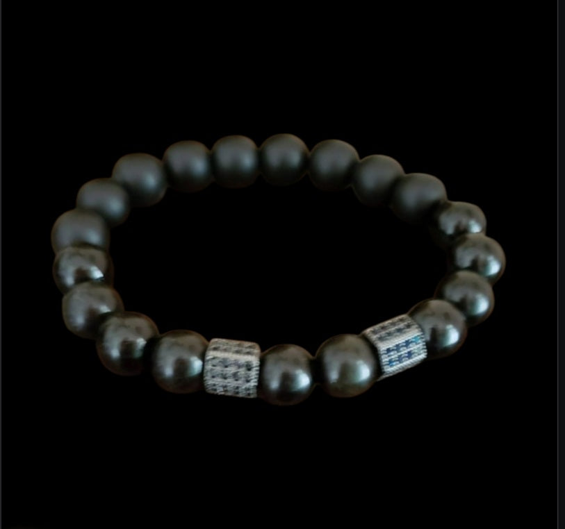 Black Obsidian Onyx Protection Bracelet handmade with natural crystal stones, including Hematite and Lava rock beads. This healing energy bracelet offers grounding and protective properties, perfect for men seeking balance, focus, and emotional strength. Ideal for yoga, meditation, or daily wear, the stylish charm design blends spiritual wellness with fashion. Unique crystal jewelry for men, handcrafted for holistic energy and intention.