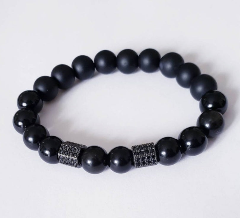 Black Obsidian Onyx Protection Bracelet handmade with natural crystal stones, including Hematite and Lava rock beads. This healing energy bracelet offers grounding and protective properties, perfect for men seeking balance, focus, and emotional strength. Ideal for yoga, meditation, or daily wear, the stylish charm design blends spiritual wellness with fashion. Unique crystal jewelry for men, handcrafted for holistic energy and intention.
