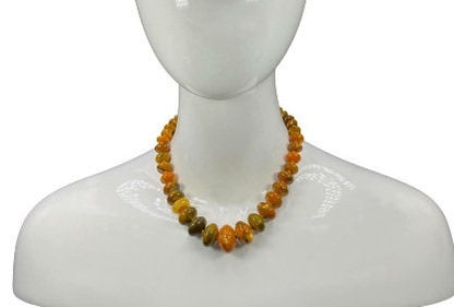Handmade chunky agate necklace for women featuring vibrant carnelian, amber, and vintage-style lucite beads in bold orange tones. This unique statement necklace blends natural gemstones with retro-inspired design, creating a one-of-a-kind accessory perfect for those who love standout jewelry. Ideal as a gift for her, it adds a warm, artistic touch to any outfit and showcases a mix of earthy elegance and vintage charm.