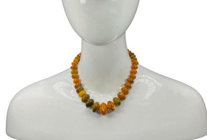Handmade chunky agate necklace for women featuring vibrant carnelian, amber, and vintage-style lucite beads in bold orange tones. This unique statement necklace blends natural gemstones with retro-inspired design, creating a one-of-a-kind accessory perfect for those who love standout jewelry. Ideal as a gift for her, it adds a warm, artistic touch to any outfit and showcases a mix of earthy elegance and vintage charm.