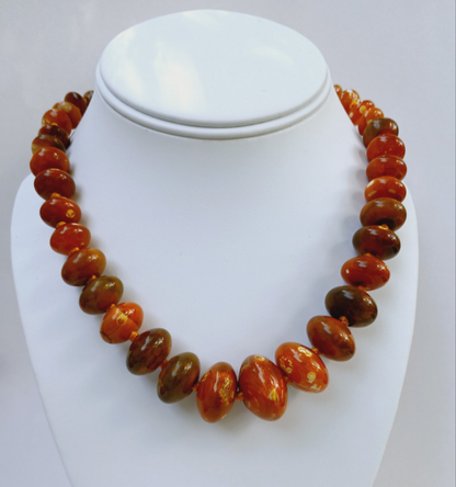Handmade chunky agate necklace for women featuring vibrant carnelian, amber, and vintage-style lucite beads in bold orange tones. This unique statement necklace blends natural gemstones with retro-inspired design, creating a one-of-a-kind accessory perfect for those who love standout jewelry. Ideal as a gift for her, it adds a warm, artistic touch to any outfit and showcases a mix of earthy elegance and vintage charm.