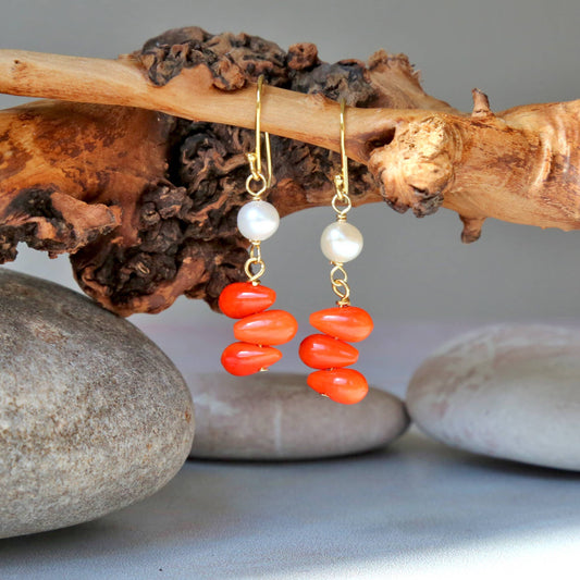 Handmade orange coral and pearl drop earrings featuring intricate beaded dangle design, perfect for women who love boho style jewelry. These statement earrings combine vibrant coral beads with elegant pearls, creating a unique accessory ideal for gifting or adding a pop of color to any outfit. Lightweight and comfortable, these coral jewelry earrings are perfect for casual or special occasions, making a bold fashion statement.