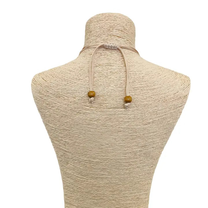 Pastel blue seashell necklace featuring an abalone pendant with natural wood beads, perfect for coastal boho beach style. Inspired by the ocean and mermaid aesthetics, this unique handmade jewelry piece makes a thoughtful gift for sea lovers. Lightweight and easy to wear, it adds a touch of seaside charm to any summer outfit. Ideal for beach vacations, festivals, or casual everyday wear with a nautical, nature-inspired vibe.