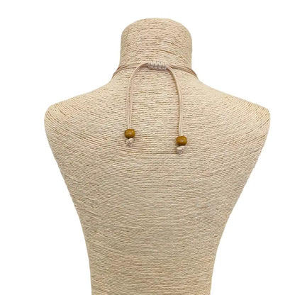 Pastel blue seashell necklace featuring an abalone pendant with natural wood beads, perfect for coastal boho beach style. Inspired by the ocean and mermaid aesthetics, this unique handmade jewelry piece makes a thoughtful gift for sea lovers. Lightweight and easy to wear, it adds a touch of seaside charm to any summer outfit. Ideal for beach vacations, festivals, or casual everyday wear with a nautical, nature-inspired vibe.