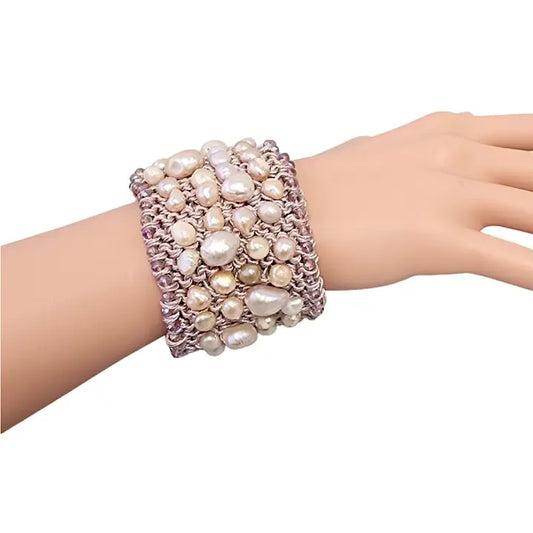 Pastel Pink Pearl Crochet Cuff Bracelet handmade with chunky freshwater pearls and shimmering thread in a soft boho style. This statement gemstone bracelet features a wide, textured design perfect for layering or wearing alone. Ideal gift for women who love unique, artisanal jewelry. Elegant yet casual, this pastel pink cuff adds a romantic, feminine touch to any outfit. Perfect for birthdays, anniversaries, or bridal accessories.