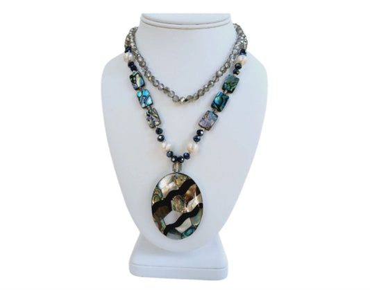 Pearl Abalone Mosaic Pendant Necklace featuring a long, chunky handmade design with shimmering mother of pearl and abalone gemstone inlays. This bold statement jewelry piece showcases natural iridescence and intricate craftsmanship, perfect for women who love unique, ocean-inspired accessories. Ideal as a birthday gift or special occasion present, it blends elegance and earthy beauty, making it a standout addition to any jewelry collection with artistic, coastal charm.