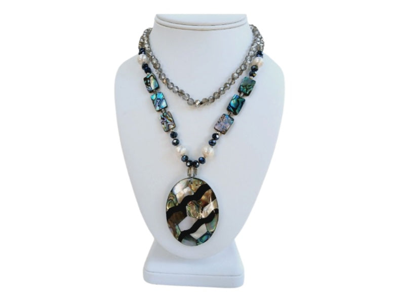 Pearl Abalone Mosaic Pendant Necklace featuring a long, chunky handmade design with shimmering mother of pearl and abalone gemstone inlays. This bold statement jewelry piece showcases natural iridescence and intricate craftsmanship, perfect for women who love unique, ocean-inspired accessories. Ideal as a birthday gift or special occasion present, it blends elegance and earthy beauty, making it a standout addition to any jewelry collection with artistic, coastal charm.