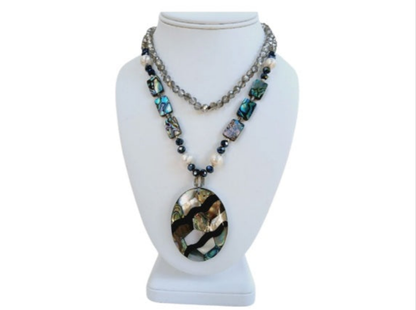 Pearl Abalone Mosaic Pendant Necklace featuring a long, chunky handmade design with shimmering mother of pearl and abalone gemstone inlays. This bold statement jewelry piece showcases natural iridescence and intricate craftsmanship, perfect for women who love unique, ocean-inspired accessories. Ideal as a birthday gift or special occasion present, it blends elegance and earthy beauty, making it a standout addition to any jewelry collection with artistic, coastal charm.