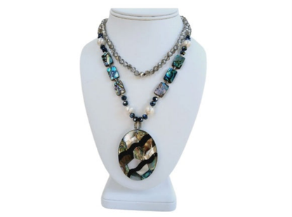Pearl Abalone Mosaic Pendant Necklace featuring a long, chunky handmade design with shimmering mother of pearl and abalone gemstone inlays. This bold statement jewelry piece showcases natural iridescence and intricate craftsmanship, perfect for women who love unique, ocean-inspired accessories. Ideal as a birthday gift or special occasion present, it blends elegance and earthy beauty, making it a standout addition to any jewelry collection with artistic, coastal charm.