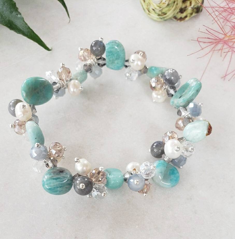 Aqua Cultured Pearl Stretch Bracelet featuring turquoise and amazonite beads in a beautifully handcrafted healing crystal jewelry design. This vibrant bracelet combines soothing blue and green tones with the lustrous glow of cultured pearls, making it an ideal gift for girls and women who appreciate handmade, spiritual accessories. Lightweight and stretchy for comfortable everyday wear, it promotes balance, calm, and positive energy while adding a stylish, boho touch to any outfit.