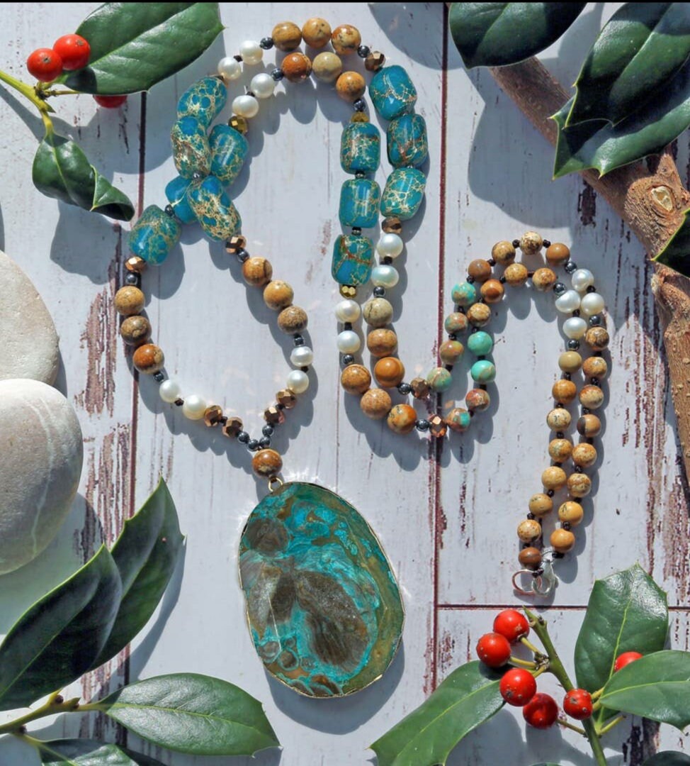 Statement Pearl Jasper Hematite Beaded Necklace featuring bold, stylish beads and a unique pendant design. This handmade jewelry piece blends lustrous pearls, earthy jasper, and sleek hematite for a striking, fashionable look. Perfect gift for women who appreciate artisanal craftsmanship and statement accessories. Ideal for adding an elegant yet edgy touch to both casual and formal outfits. Unique fashion jewelry crafted with care and style.