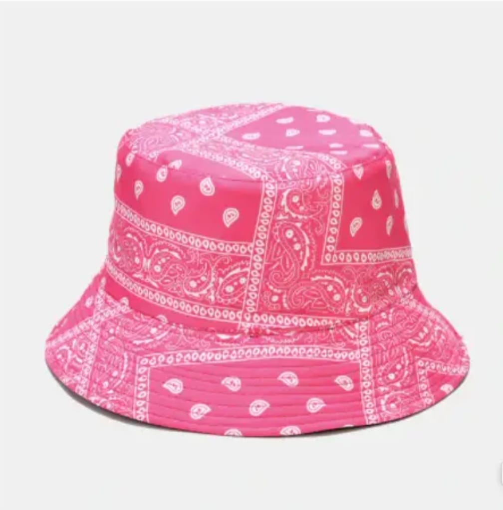 Pink paisley print bandana bucket hat designed for lightweight comfort and sun protection. This trendy unisex hat is perfect for spring and summer wear, offering a stylish look for beach days, travel, festivals, or casual outings. With its eye-catching paisley design and breathable fabric, this bucket hat combines fashion and function. Stay cool, shaded, and on-trend with this versatile warm-weather accessory.