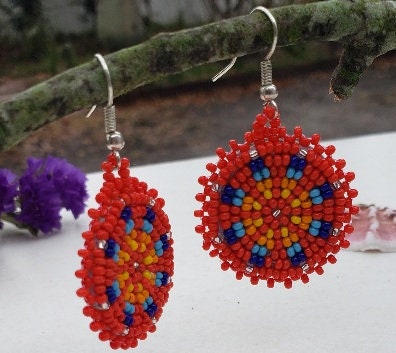 Red Handmade Beaded Earrings for women featuring vibrant native-style beadwork with multicolor accents in a bold boho medallion design. These statement festival earrings showcase intricate craftsmanship and colorful patterns, perfect for adding a pop of color to any outfit. Ideal gift for women who appreciate unique, artisanal jewelry with cultural significance. Lightweight and striking, these earrings elevate both casual and festive looks with artistic flair.
