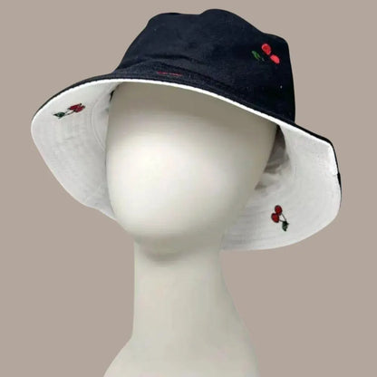 Reversible Cherry Bucket Hat for men and women featuring a fun cherry print on one side and a solid color on the other, offering two stylish looks in one. This lightweight, breathable summer hat is perfect for vacations, casual outings, beach days, and travel. Water-resistant material makes it ideal for light rain and unexpected weather. Unisex design fits most head sizes comfortably, combining fashion and function for everyday outdoor wear.