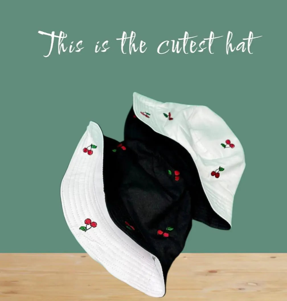 Reversible Cherry Bucket Hat for men and women featuring a fun cherry print on one side and a solid color on the other, offering two stylish looks in one. This lightweight, breathable summer hat is perfect for vacations, casual outings, beach days, and travel. Water-resistant material makes it ideal for light rain and unexpected weather. Unisex design fits most head sizes comfortably, combining fashion and function for everyday outdoor wear.