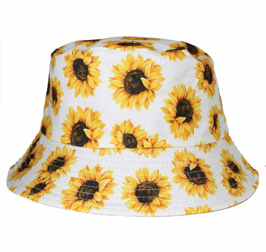 Sunflower Bucket Hat in vibrant yellow with a reversible floral boho design, perfect for summer travel, beach days, or vacation wear. This lightweight fisherman hat offers stylish sun protection for women, blending comfort with bold, cheerful vibes. Ideal for outdoor adventures, festivals, or casual outings, it’s a must-have accessory for warm-weather wardrobes. A fun and functional gift for women who love fashion with a carefree, sunny flair.