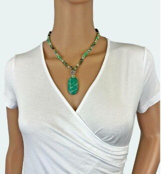 Amazonite, Jasper, and Quartz Multi-Stone Necklace featuring a unique Russian pendant design, handcrafted into a bold boho statement necklace for women. This green-toned jewelry piece blends natural gemstones to create a vibrant accessory full of healing energy and artistic charm. Perfect as a handmade gift for her, it adds a distinctive touch to any outfit, ideal for everyday wear or special occasions, combining artisanal craftsmanship with natural beauty.