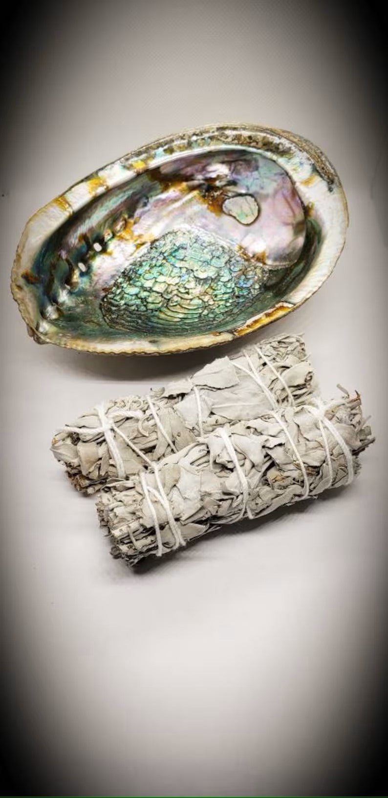 Complete smudging kit featuring California white sage bundles and a natural abalone shell, designed for spiritual cleansing and purification rituals. This handcrafted set is perfect for housewarming gifts or personal wellness practices, helping to clear negative energy and promote positive vibes. Ideal for those who practice smudging ceremonies, meditation, or energy healing, combining traditional elements in a beautiful, easy-to-use ritual kit.