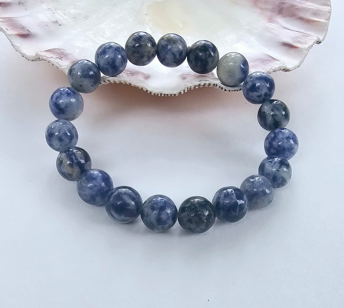 Handmade Sodalite Bracelet featuring natural healing crystals, designed as a mala bead chakra bracelet for meditation and spiritual balance. This Dumortierite-infused jewelry piece promotes calm, clarity, and emotional healing, suitable for both men and women. Perfect as a meaningful gift for mindfulness practitioners, yoga lovers, or anyone seeking positive energy. Stylish, durable, and crafted with care for everyday wear or meditation sessions.