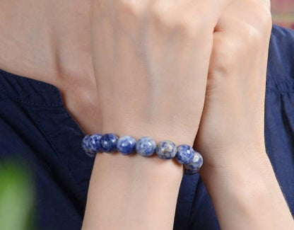 Handmade Sodalite Bracelet featuring natural healing crystals, designed as a mala bead chakra bracelet for meditation and spiritual balance. This Dumortierite-infused jewelry piece promotes calm, clarity, and emotional healing, suitable for both men and women. Perfect as a meaningful gift for mindfulness practitioners, yoga lovers, or anyone seeking positive energy. Stylish, durable, and crafted with care for everyday wear or meditation sessions.