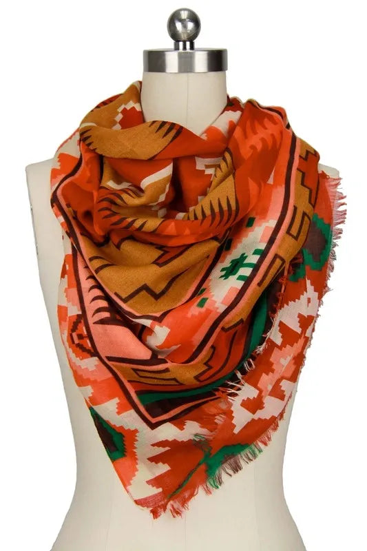 Southwestern print scarf for women featuring an oversized design with bold tribal and boho patterns. Made from soft, breathable viscose, this vibrant western-style shawl is perfect for fall and winter fashion. The rich, warm colors and intricate design make it a versatile wrap for chilly days, adding a statement to any outfit. Ideal for layering, this stylish scarf blends comfort, warmth, and bold seasonal style.