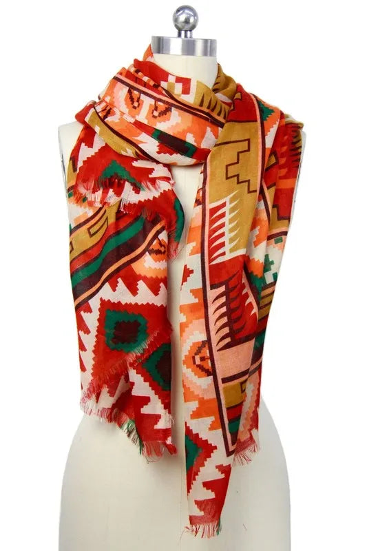 Southwestern print scarf for women featuring an oversized design with bold tribal and boho patterns. Made from soft, breathable viscose, this vibrant western-style shawl is perfect for fall and winter fashion. The rich, warm colors and intricate design make it a versatile wrap for chilly days, adding a statement to any outfit. Ideal for layering, this stylish scarf blends comfort, warmth, and bold seasonal style.