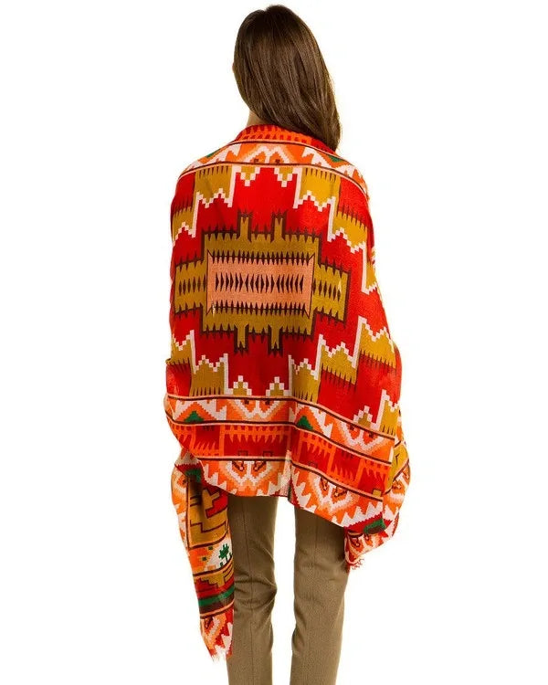 Southwestern print scarf for women featuring an oversized design with bold tribal and boho patterns. Made from soft, breathable viscose, this vibrant western-style shawl is perfect for fall and winter fashion. The rich, warm colors and intricate design make it a versatile wrap for chilly days, adding a statement to any outfit. Ideal for layering, this stylish scarf blends comfort, warmth, and bold seasonal style.