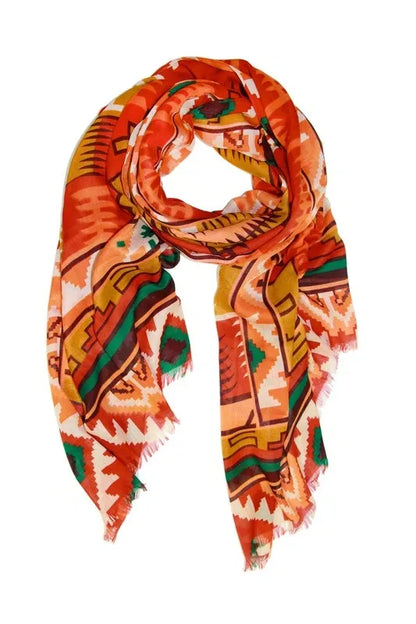 Southwestern print scarf for women featuring an oversized design with bold tribal and boho patterns. Made from soft, breathable viscose, this vibrant western-style shawl is perfect for fall and winter fashion. The rich, warm colors and intricate design make it a versatile wrap for chilly days, adding a statement to any outfit. Ideal for layering, this stylish scarf blends comfort, warmth, and bold seasonal style.