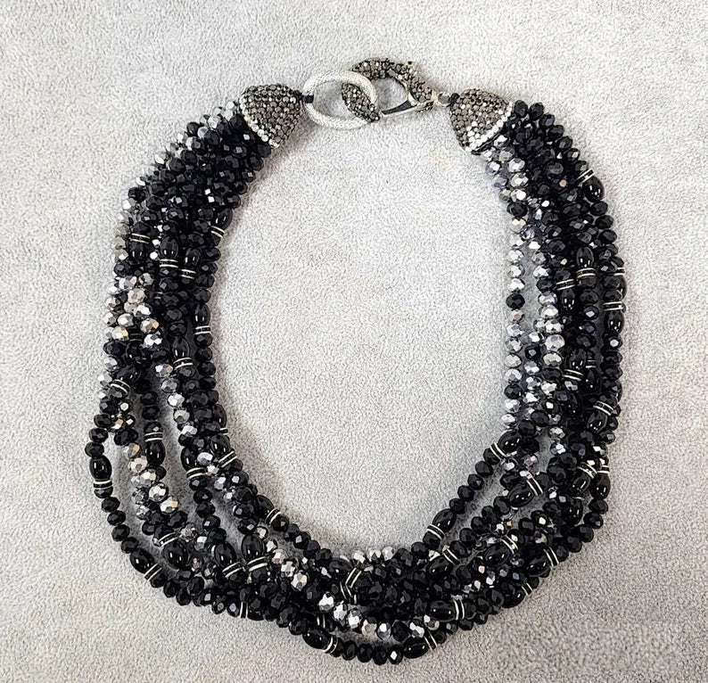 Black silver crystal torsade choker necklace featuring chunky, bold crystals for a striking statement look. Designed for women who want glamorous evening jewelry, this elegant choker adds sparkle and sophistication to any outfit. Perfect as a gift for her, it combines modern style with timeless glam. Ideal for special occasions, parties, or formal events, this crystal necklace delivers eye-catching allure and confident, bold fashion.