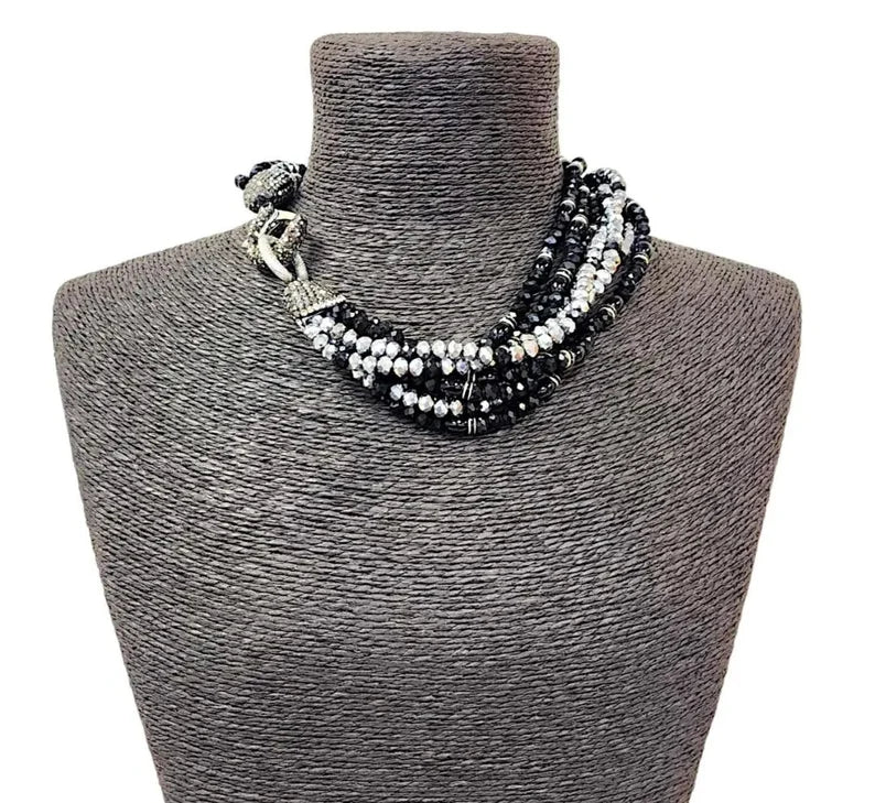Black silver crystal torsade choker necklace featuring chunky, bold crystals for a striking statement look. Designed for women who want glamorous evening jewelry, this elegant choker adds sparkle and sophistication to any outfit. Perfect as a gift for her, it combines modern style with timeless glam. Ideal for special occasions, parties, or formal events, this crystal necklace delivers eye-catching allure and confident, bold fashion.
