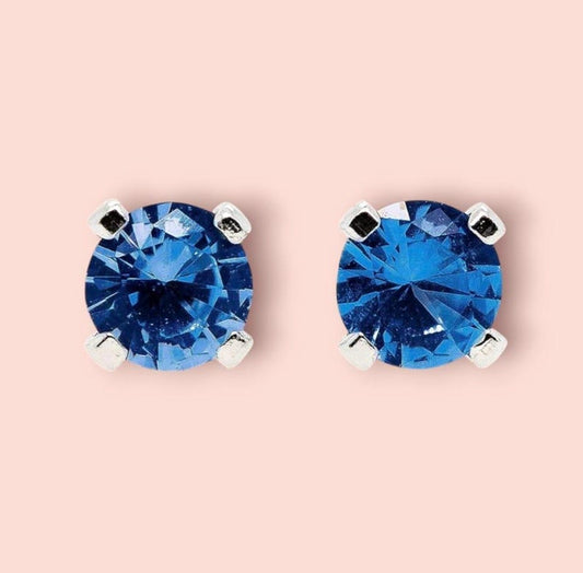 Blue Sapphire Sterling Silver Stud Earrings featuring dazzling deep blue gemstones in a minimalist setting. These elegant birthstone earrings are perfect for women who love dainty, timeless jewelry with meaningful detail. Ideal as a September birthday or anniversary gift, they offer a refined, sophisticated touch for everyday wear or special occasions.Handcrafted with care, these studs make a thoughtful gift for her, blending simplicity, elegance, and personal significance in one classic design.