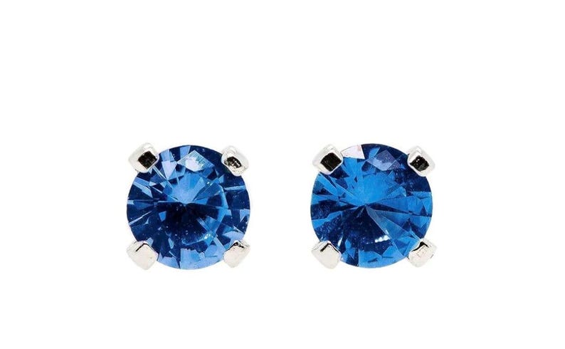 Blue Sapphire Sterling Silver Stud Earrings featuring dazzling deep blue gemstones in a minimalist setting. These elegant birthstone earrings are perfect for women who love dainty, timeless jewelry with meaningful detail. Ideal as a September birthday or anniversary gift, they offer a refined, sophisticated touch for everyday wear or special occasions.Handcrafted with care, these studs make a thoughtful gift for her, blending simplicity, elegance, and personal significance in one classic design.