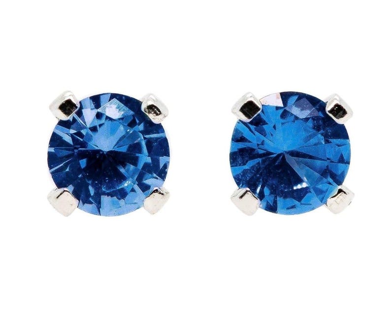 Blue Sapphire Sterling Silver Stud Earrings featuring dazzling deep blue gemstones in a minimalist setting. These elegant birthstone earrings are perfect for women who love dainty, timeless jewelry with meaningful detail. Ideal as a September birthday or anniversary gift, they offer a refined, sophisticated touch for everyday wear or special occasions.Handcrafted with care, these studs make a thoughtful gift for her, blending simplicity, elegance, and personal significance in one classic design.