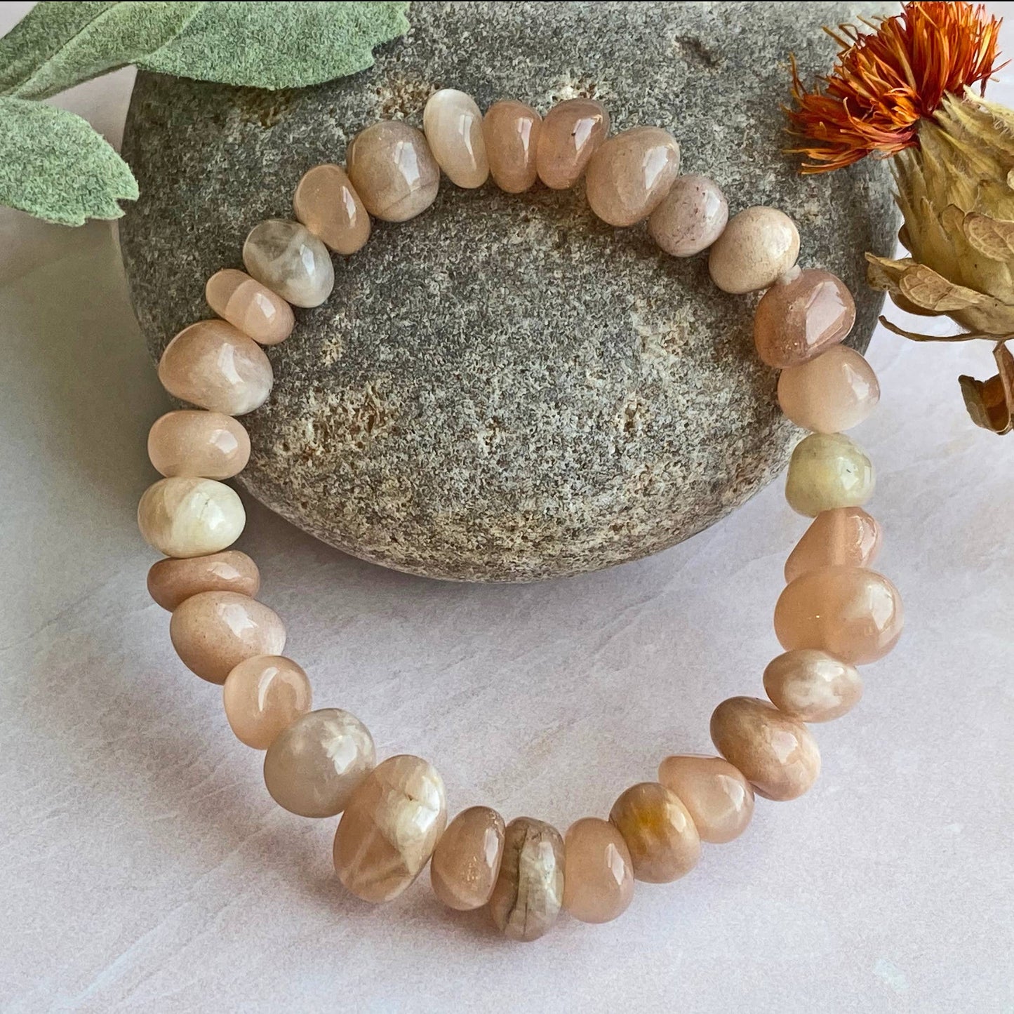 Genuine Sunstone Nugget Stretch Bracelet featuring handmade crystal beads designed for women who appreciate natural healing gemstone jewelry. This artisanal sunstone bracelet showcases radiant orange hues symbolizing positivity and energy. Lightweight and comfortable, it makes a thoughtful gift for her, perfect for spiritual wellness or everyday wear. Combining vibrant sunstone nuggets with stretchy design, this bracelet blends style, healing properties, and handcrafted elegance.
