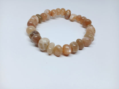 Genuine Sunstone Nugget Stretch Bracelet featuring handmade crystal beads designed for women who appreciate natural healing gemstone jewelry. This artisanal sunstone bracelet showcases radiant orange hues symbolizing positivity and energy. Lightweight and comfortable, it makes a thoughtful gift for her, perfect for spiritual wellness or everyday wear. Combining vibrant sunstone nuggets with stretchy design, this bracelet blends style, healing properties, and handcrafted elegance.