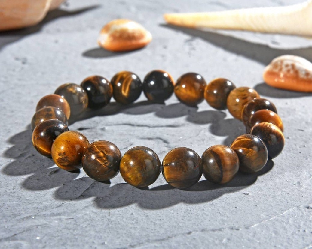 Tiger Eye Bracelet for men featuring natural healing crystals known for protection, strength, and balance. This stylish spiritual jewelry is designed to promote positive energy and calm, making it a meaningful gift for him—perfect for husbands or boyfriends. Handmade with quality beads, it combines durability and fashion for everyday wear. Ideal for meditation, casual outfits, or special occasions, blending wellness with masculine style.